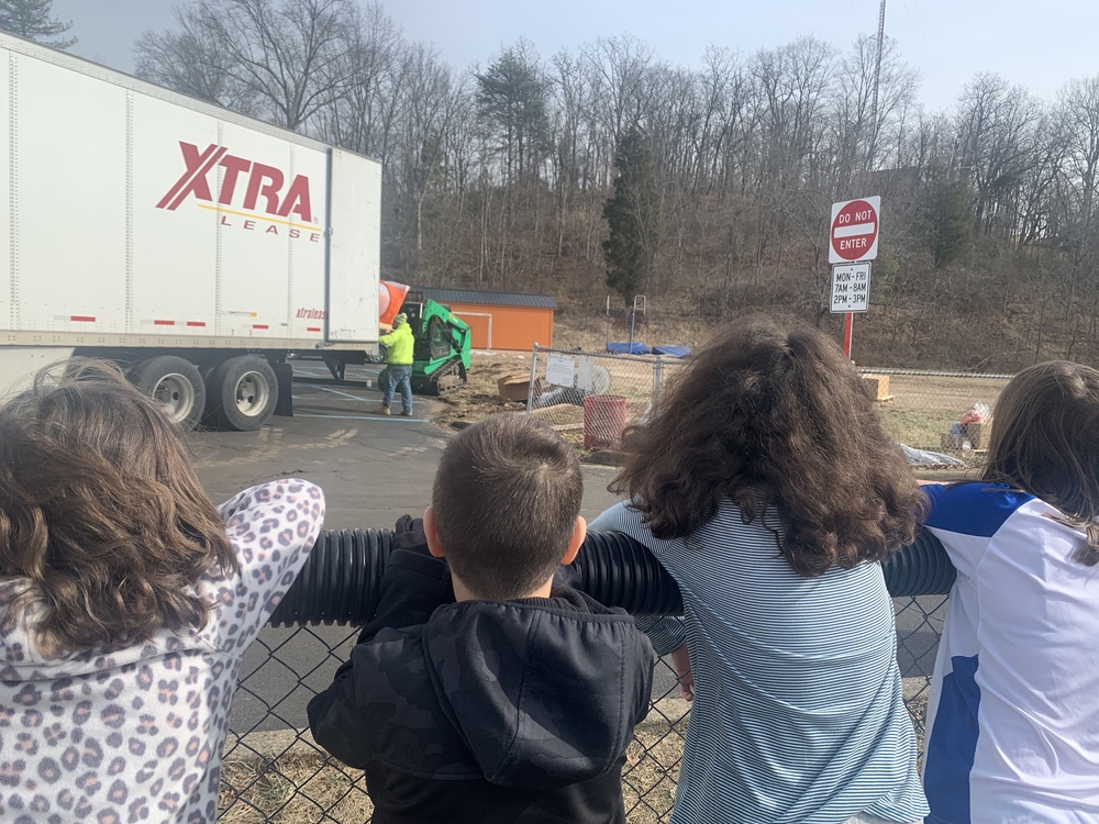 children watch unloading semitrailer