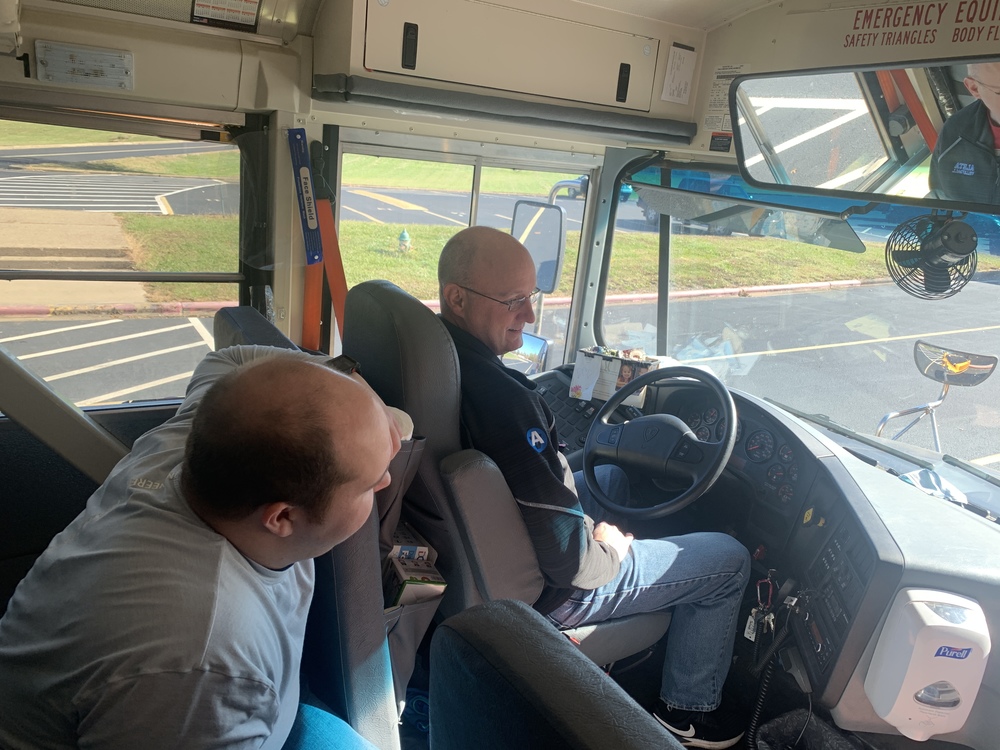 Tom Short teaches Matt Evans to drive a bus