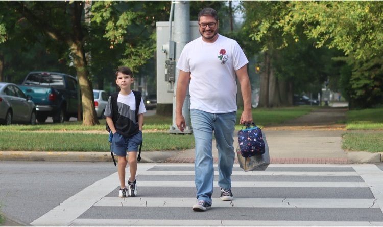 student walks to school with parent